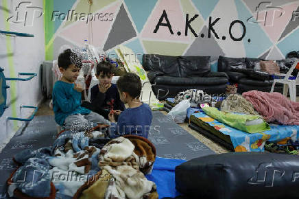 Israelis gather at a bomb shelter following rocket attacks from Lebanon towards Israel, in Acre