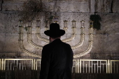 Hostages' families participate in lighting of first Hanukkah candle at Western Wall in Jerusalem