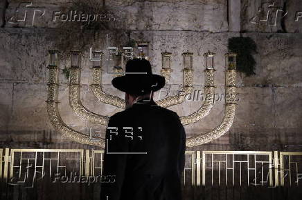 Hostages' families participate in lighting of first Hanukkah candle at Western Wall in Jerusalem