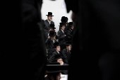 Ultra Orthodox Jews light Hanukkah holiday candles in Jerusalem