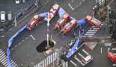 An aerial view shows rescue operations underway at a large sinkhole that swallowed a truck at an intersection in Yashio