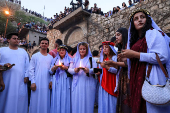 Iraqi Yazidi women light candles on the occasion of Red Wednesday, a ceremony to celebrate the Yazidi New Year at Lalish temple in Shekhan District in Duhok province
