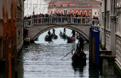 Gondoliers row their gondolas through the Venice Canal ahead of Pope Francis's visit in Venice