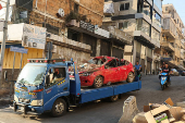 People gather at the site of an Israeli strike in Beirut's southern suburbs