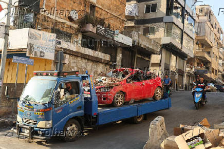 People gather at the site of an Israeli strike in Beirut's southern suburbs