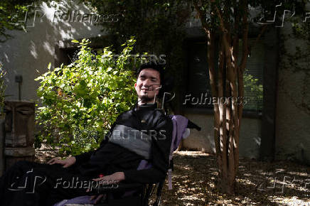 First-time voter Yeshua Loya, 21, poses for a portrait at The Plaza assisted living facility in Scottsdale