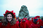 Revellers attend winter solstice celebrations during sunrise at Stonehenge stone circle near Amesbury