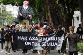 Demonstrators march during a Human Rights Day rally in Jakarta