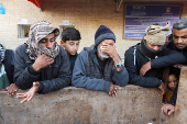 Palestinians mourn loved ones killed in Israeli strikes, in Deir Al-Balah in the central Gaza Strip