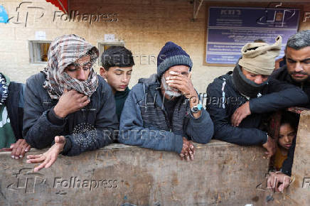 Palestinians mourn loved ones killed in Israeli strikes, in Deir Al-Balah in the central Gaza Strip