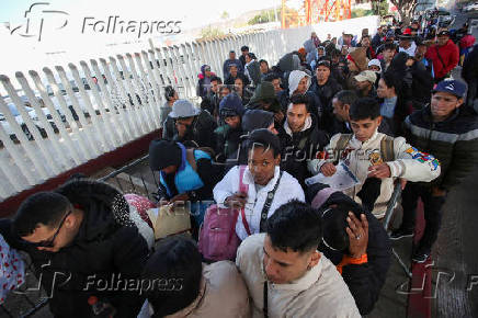 Migrants gather at El Chaparral border crossing after their CBP One app asylum appointment was cancelled on the day of U.S. President Donald Trump's inauguration, in Tijuana