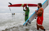 Surfing Santas take to the waves at the annual Christmas Eve event in Cocoa Beach