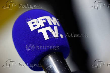 The logo of BFM Business TV is seen on a microphone
