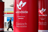 FILE PHOTO: Logos of Woodside Petroleum are seen at Gastech, the world's biggest expo for the gas industry, in Chiba