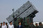 Taiwanese President Lai Ching-te is seen in front of the Hsiung Feng III mobile missile launcher during a visit to the base in response to recent Chinese military drills, in Taoyuan