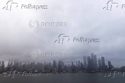 Clouds are pictured over the skyline of New York during a rainy day as it is seen from Weehawken, New Jersey