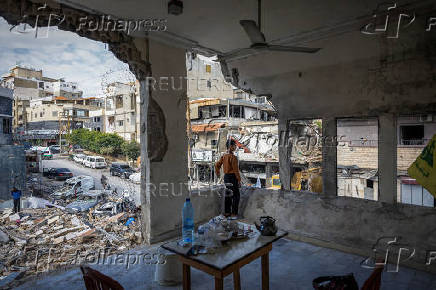 Jad Arouni, 10, stands inside his house damaged in an Israeli strike, after the ceasefire between Israel and Hezbollah, in Tyre