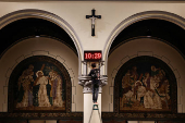 A man sets a digital clock to prepare for the Christmas mass at the Jakarta Cathedral in Jakarta