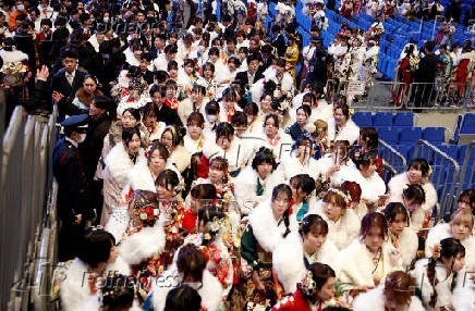 Youth including the Kimono-clad women leave the venue after their Coming of Age Day celebration ceremony in Yokohama