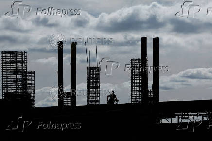 FILE PHOTO: Construction worker silhouetted during morning light