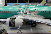 FILE PHOTO: A worker walks past Boeing's 737 MAX-9 under construction at their production facility in Renton, Washington