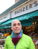 Joseph, owner of Panzer's, poses outside delicatessen in London