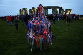 Revellers attend winter solstice celebrations during sunrise at Stonehenge stone circle near Amesbury