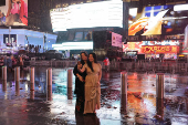 People gather at Times Square to watch the ball drop on New Year's Eve in New York City