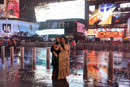 People gather at Times Square to watch the ball drop on New Year's Eve in New York City