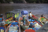 A person stands on a boat, after attacks by rebels from the leftist National Liberation Army (ELN) in Tibu