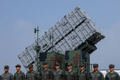 Members of the Taiwanese navy Hai Feng (Sea Blade) Group stand in front of Hsiung Feng III mobile missile launcher during Taiwanese President Lai Ching-te?s visit to the base in response to recent Chinese military drills, in Taoyuan