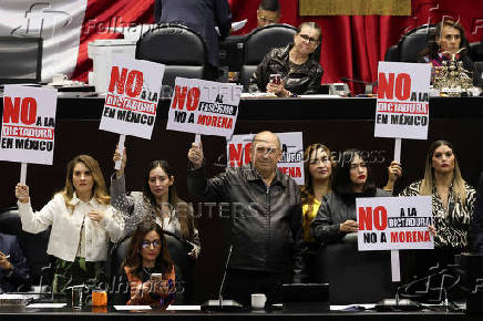 Congress members oppose a reform during a session, in Mexico City