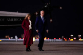 U.S. President Joe Biden and first lady Jill Biden walk on the tarmac as they depart for Joint Base Andrews from John F. Kennedy International Airport in New York