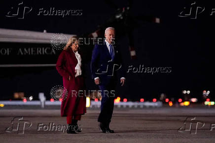 U.S. President Joe Biden and first lady Jill Biden walk on the tarmac as they depart for Joint Base Andrews from John F. Kennedy International Airport in New York