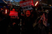 Pro-Yoon protesters are seen in the early light after rallying throughout the night in support of impeached South Korean President Yoon Suk Yeol near his official residence, in Seoul