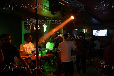 People visit a local pub in Lagos