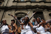 Revellers take part in the 'Chora Me Liga' block party during a pre-Carnival parade in Rio de Janeiro