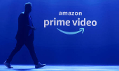 FILE PHOTO: A man walks past a logo of Amazon Prime Video during a launch event in Mumbai