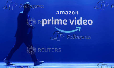 FILE PHOTO: A man walks past a logo of Amazon Prime Video during a launch event in Mumbai