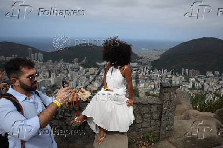 A man takes photos from the Dona Marta lookout point in Rio de Janeiro