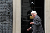 British Deputy Foreign Secretary and Minister of State (Development and Africa) Mitchell walks on Downing Street, in London