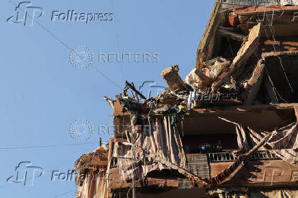 People gather at the site of an Israeli strike in Beirut's southern suburbs