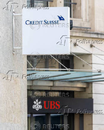 FILE PHOTO: The logos of Swiss bank Credit Suisse and UBS are seen in Geneva