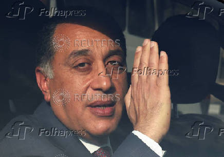 Egyptian Prime Minister Mostafa Madbouly looks on after visiting the place where trucks carrying Egyptian humanitarian aid wait to start moving to the Rafah border crossing to enter Gaza, amid a ceasefire between Israel and Hamas, in Cairo