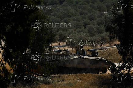 An Israeli soldier sits in a military vehicle near Israel's border with Gaza