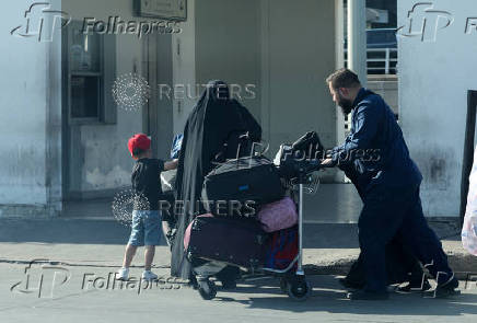 A man pushes a cart with luggage outside Beirut-Rafic Hariri International Airport