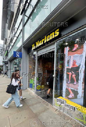 FILE PHOTO: People enter in a Dr. Martens store in Manchester