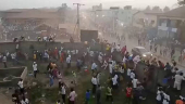 People scramble in Nzerekore where local officials said a stampede occurred following clashes at a soccer match