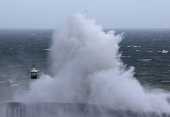 Large waves crash over the harbour wall as Storm Nelson arrives at Newhaven