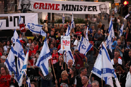 People attend a protest against Israeli Prime Minister Benjamin Netanyahu's government in Tel Aviv